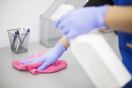 Professional office cleaners working in an E8 workspace